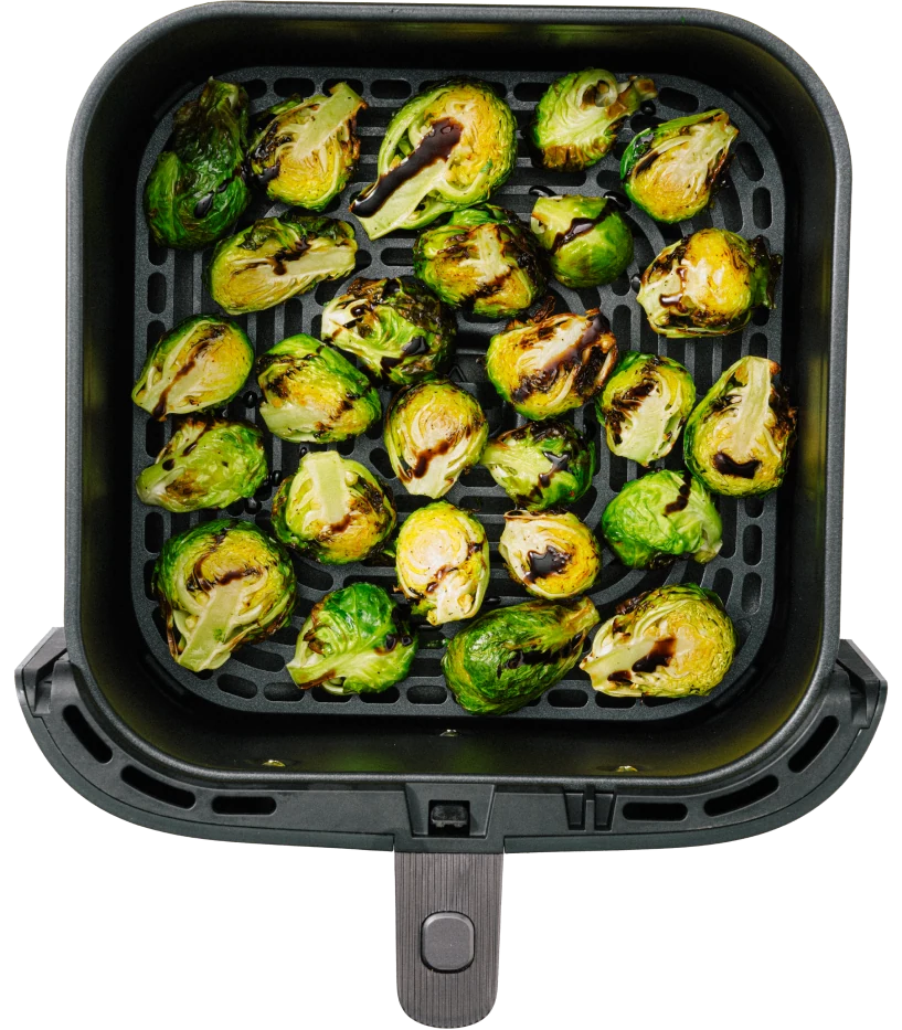 A basket filled with roasted Brussels sprouts, showcasing a mix of green and charred brown colors.