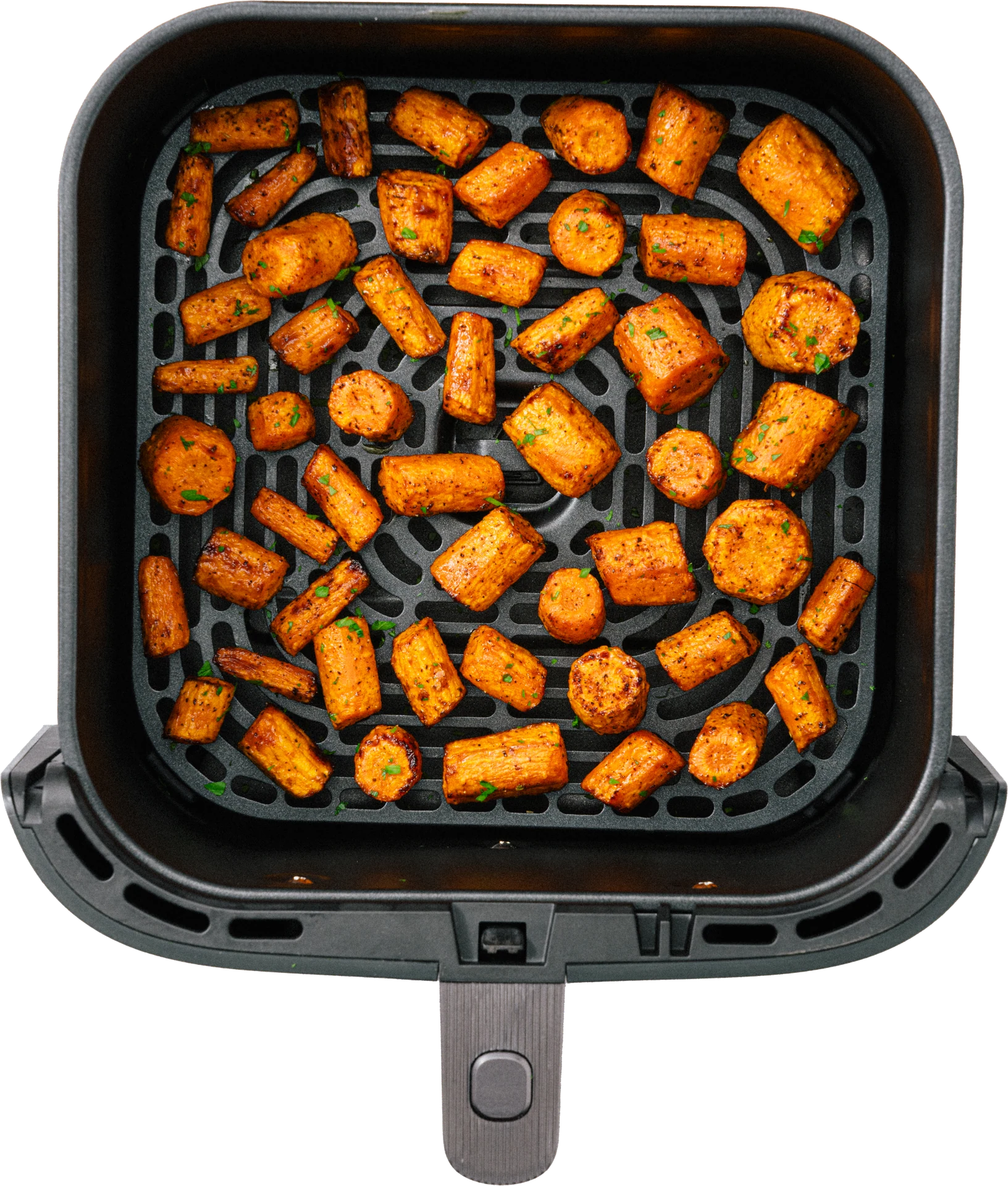 A top view of a black air fryer basket filled with golden-brown roasted carrot pieces, garnished with green herbs.